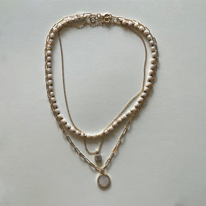 The white Saint Benedict and white necklace