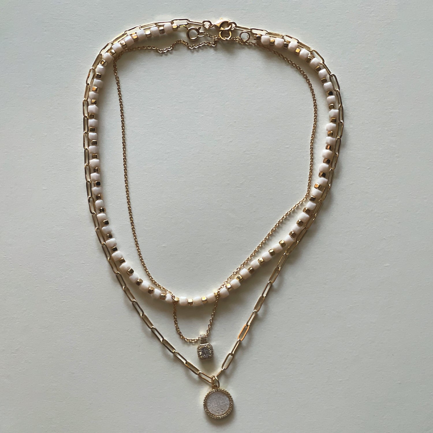 The white Saint Benedict and white necklace