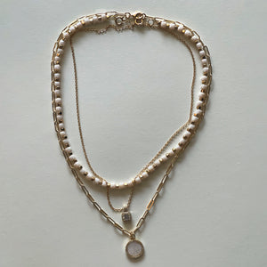 The white Saint Benedict and white necklace
