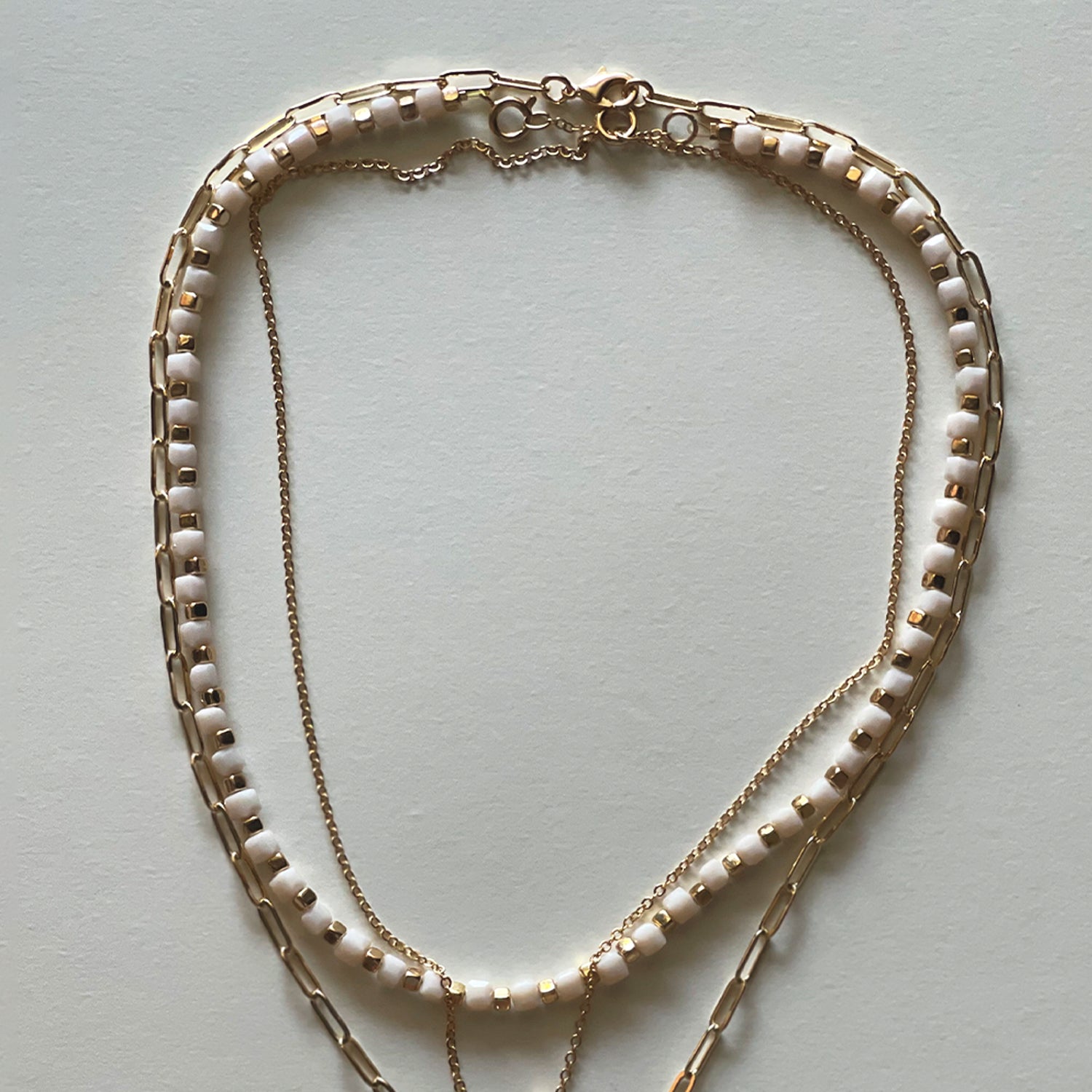 The white Saint Benedict and white necklace