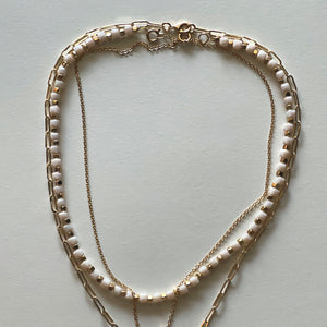 The white Saint Benedict and white necklace