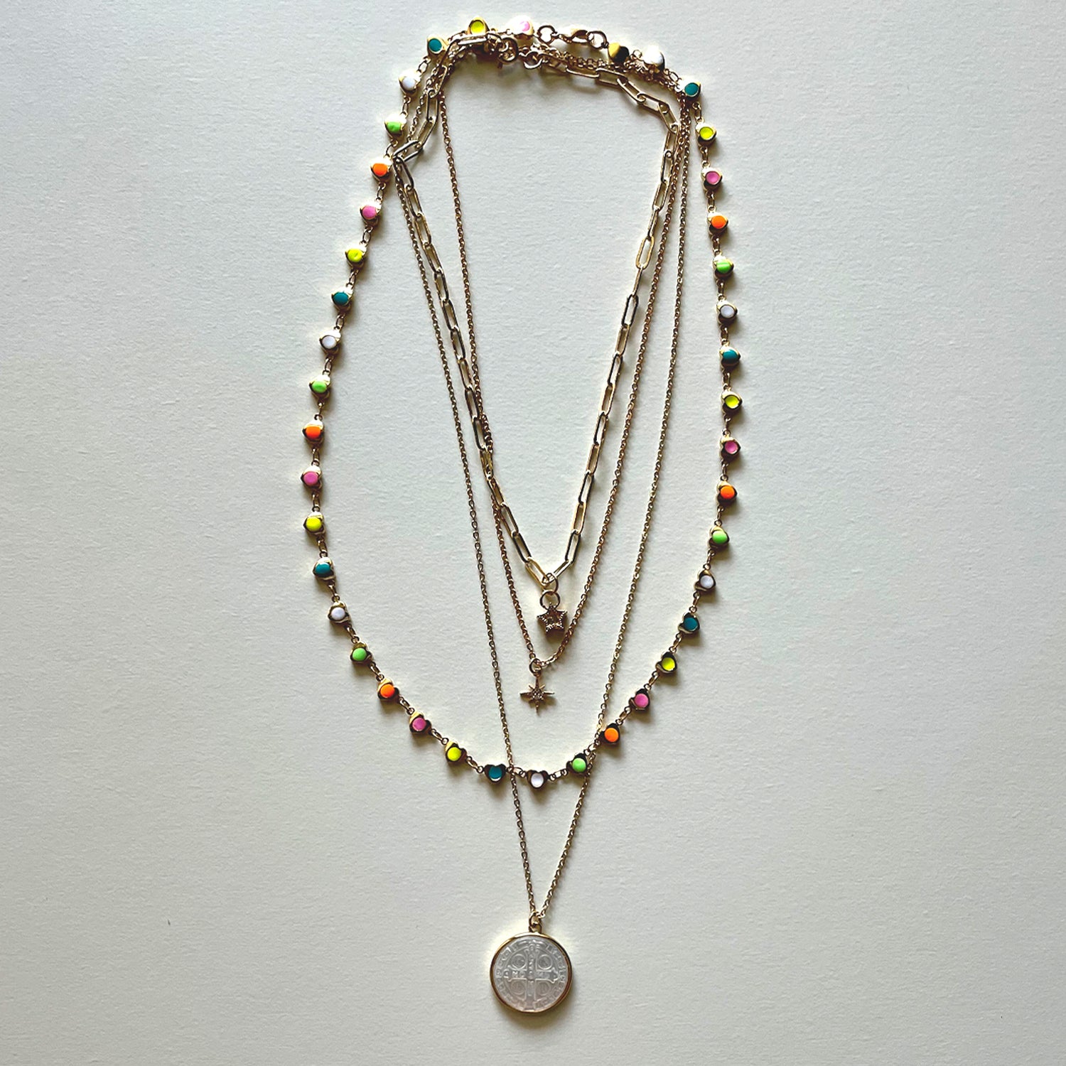 The white Saint Benedict and hearts necklaces