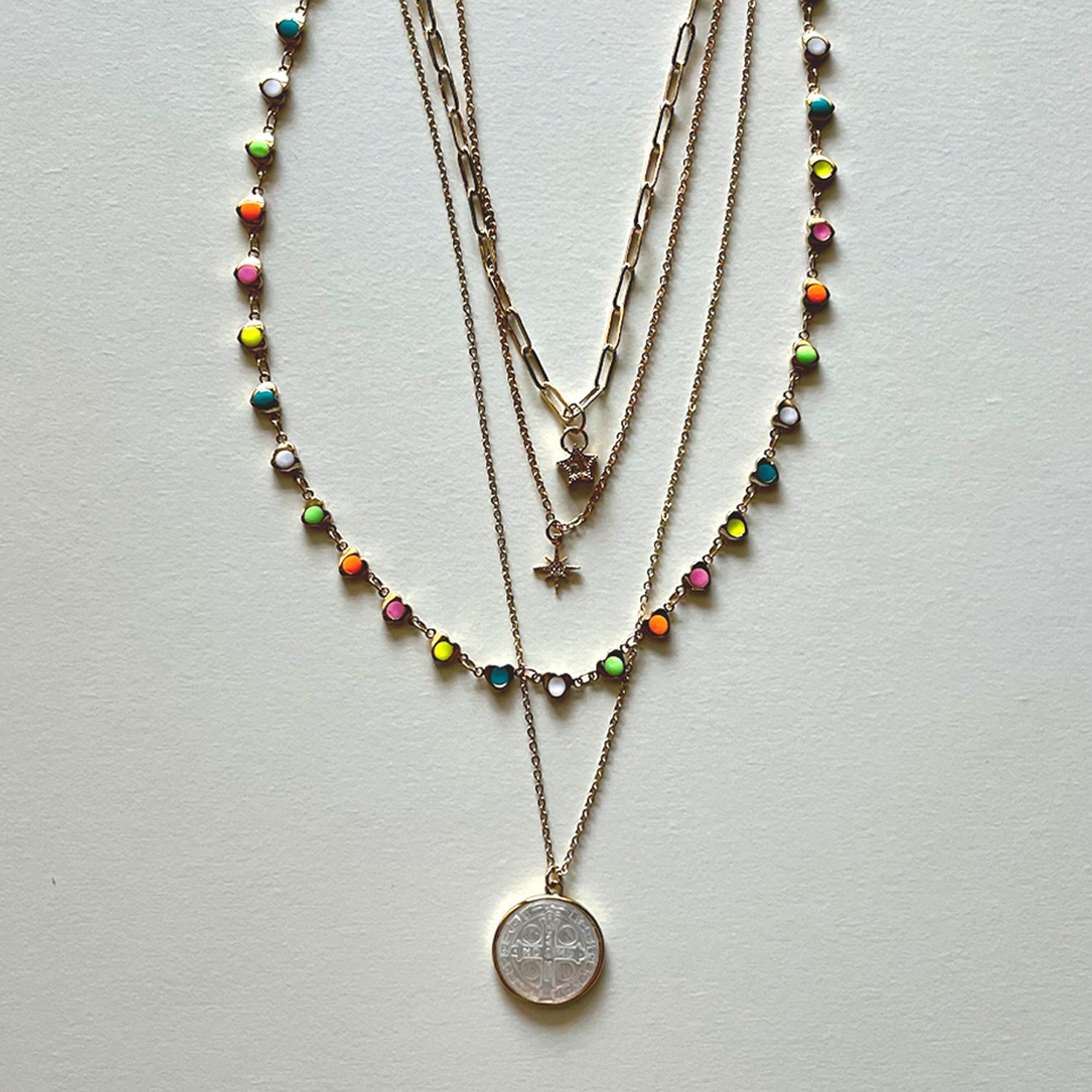 The white Saint Benedict and hearts necklaces