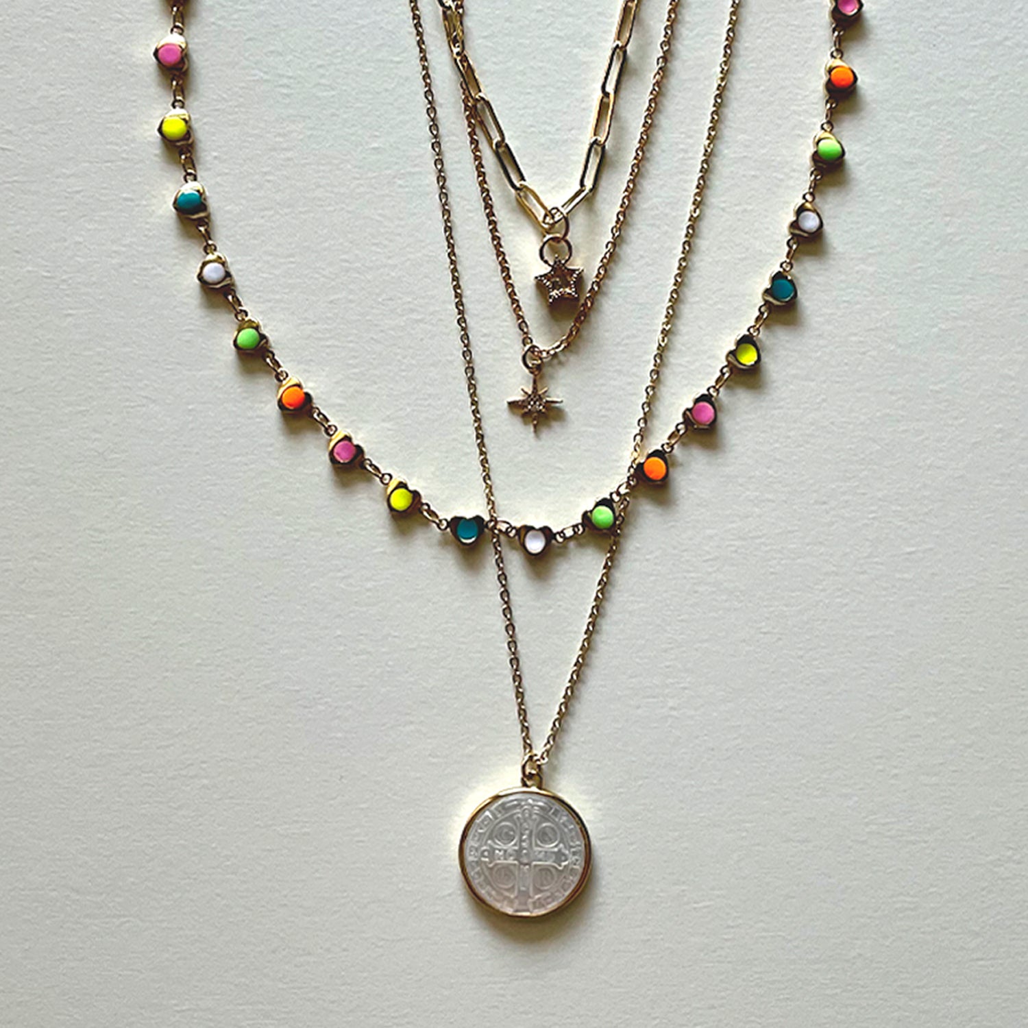 The white Saint Benedict and hearts necklaces