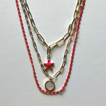 Load image into Gallery viewer, The white Saint Benedict and pink star necklaces

