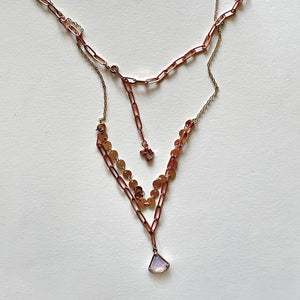 The white stone and rosa gold necklace
