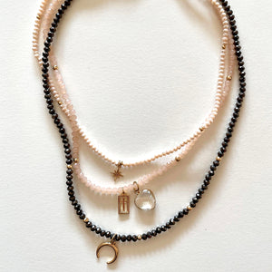 The pink and black necklace