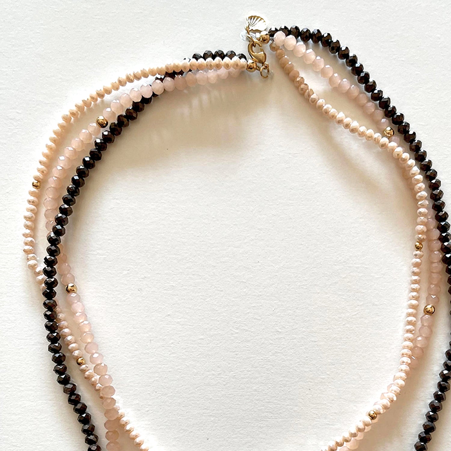 The pink and black necklace