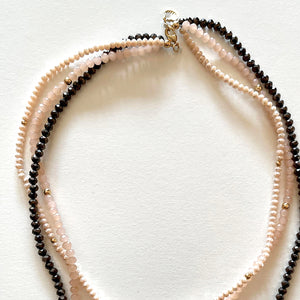 The pink and black necklace